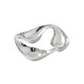 Modern silver two-compartment bowl with almonds on a gray surface