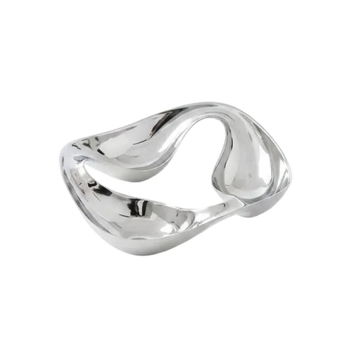 Modern silver two-compartment bowl with almonds on a gray surface